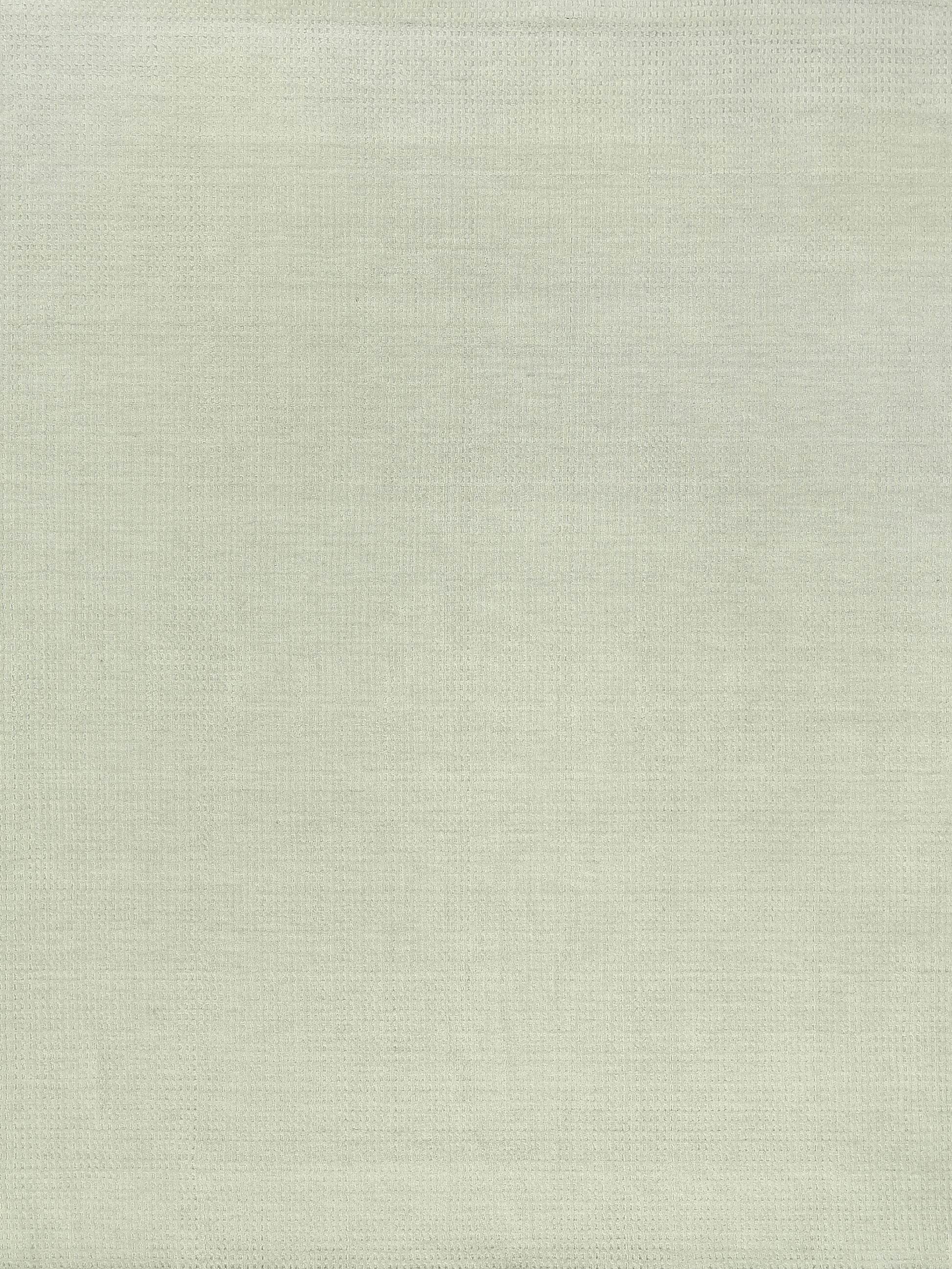 Beige New Zealand wool rug with a subtle hand-loomed weave; indoor use, 6' x 9'.