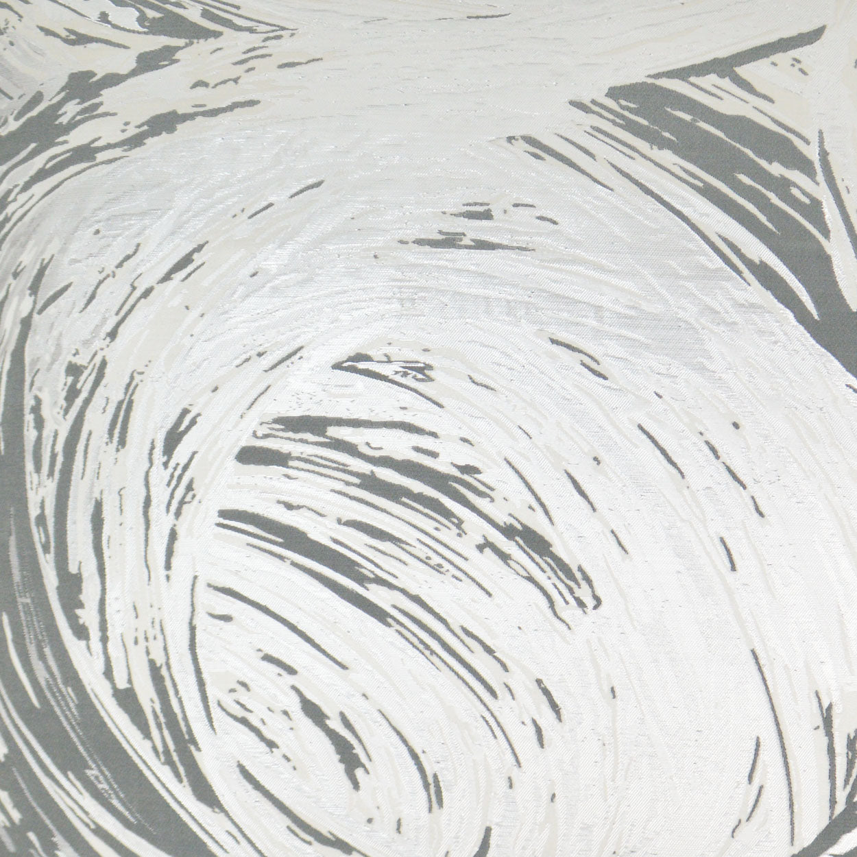 Abstract gray and white swirling fabric pattern with brush-stroke texture, ideal for upholstery or decor.