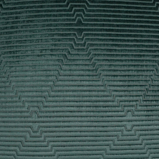 Teal fabric close-up with raised stepped chevron pattern.