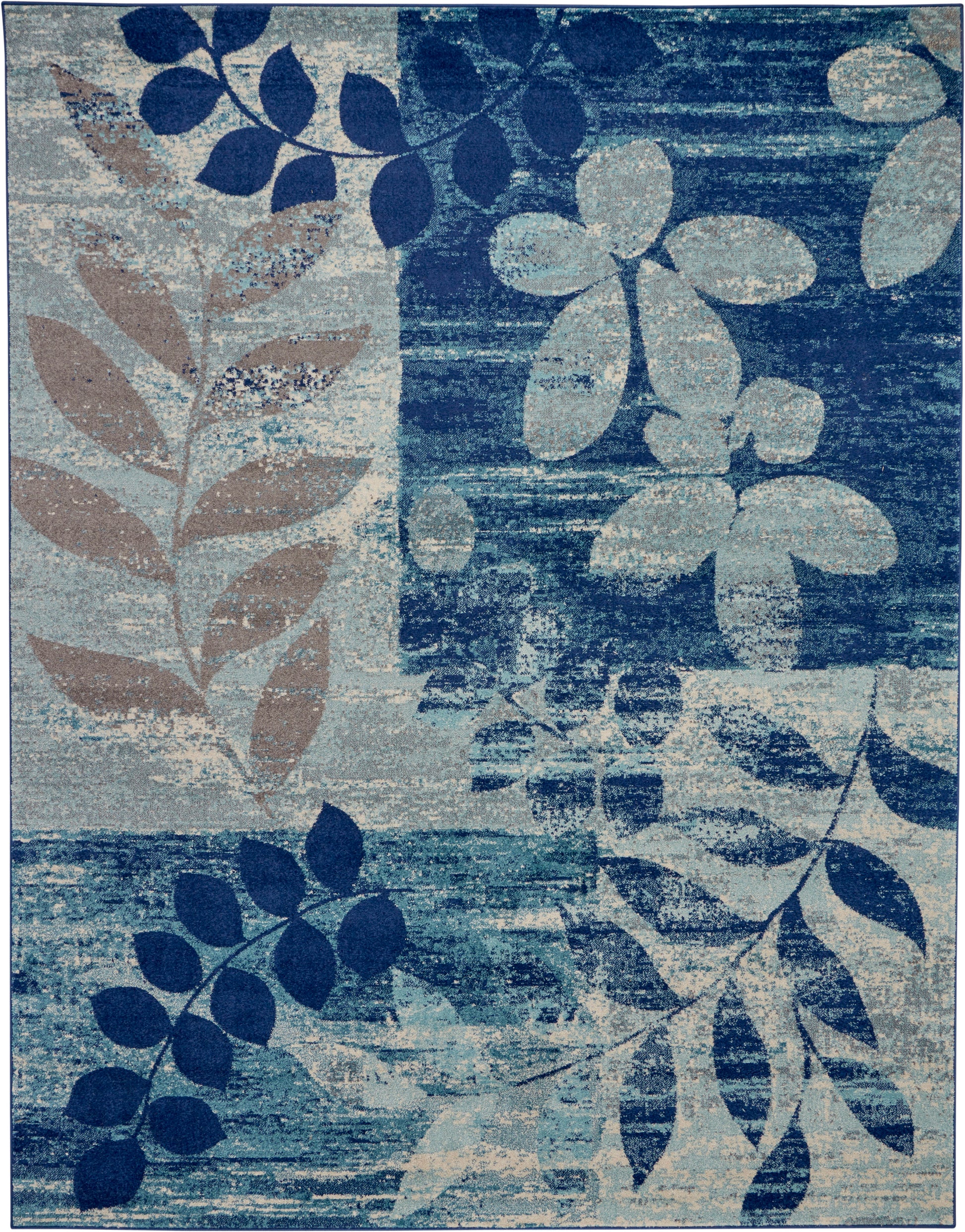 Abstract floral blue area rug with navy, teal and beige leaves; distressed texture.