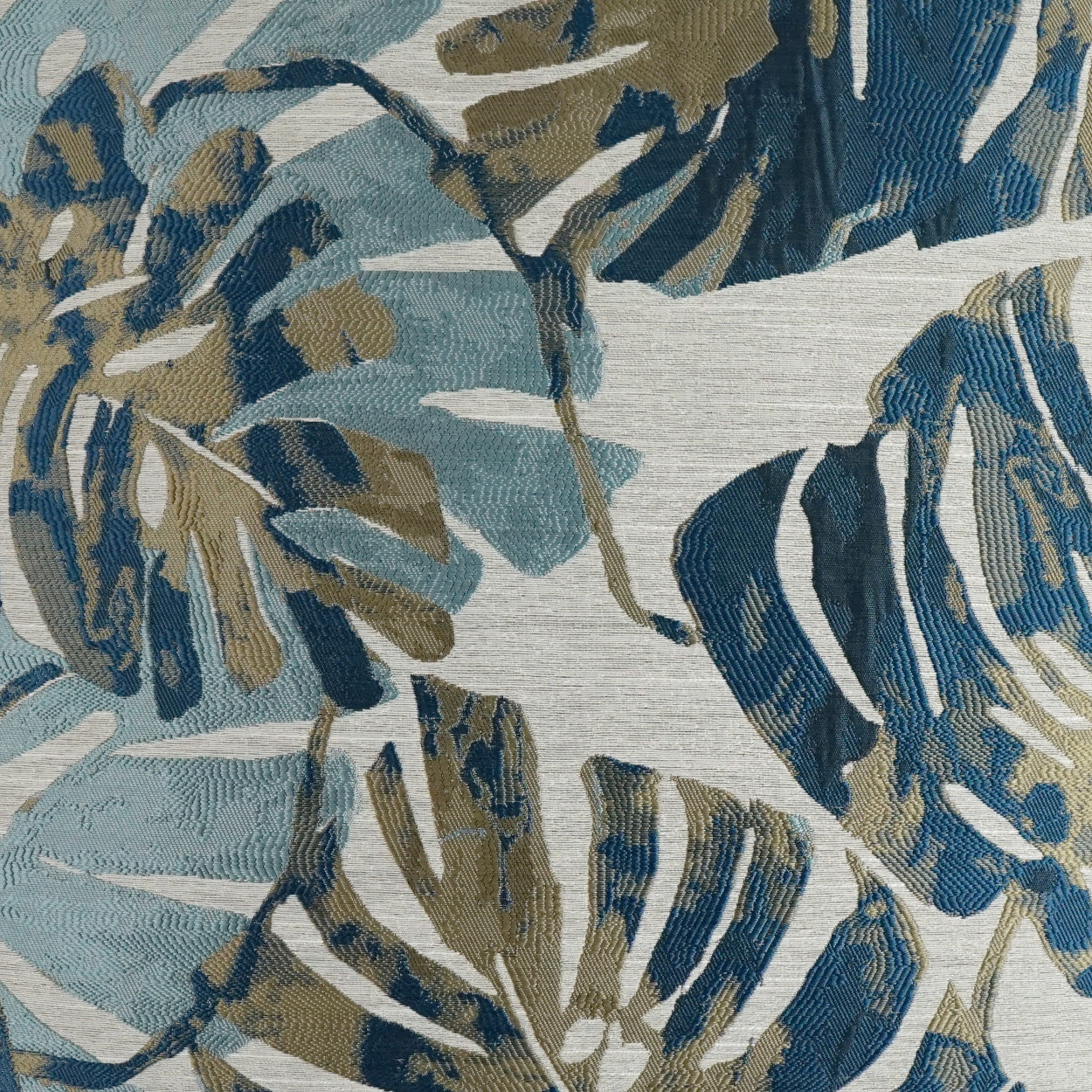 Botanical leaf print fabric in blues, teals, and taupe on light heather gray; woven textile for upholstery or drapes.