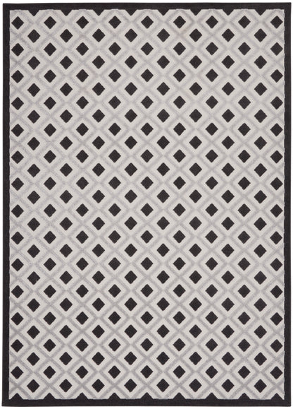 Cream woven rug with black diamond lattice pattern and dark border.