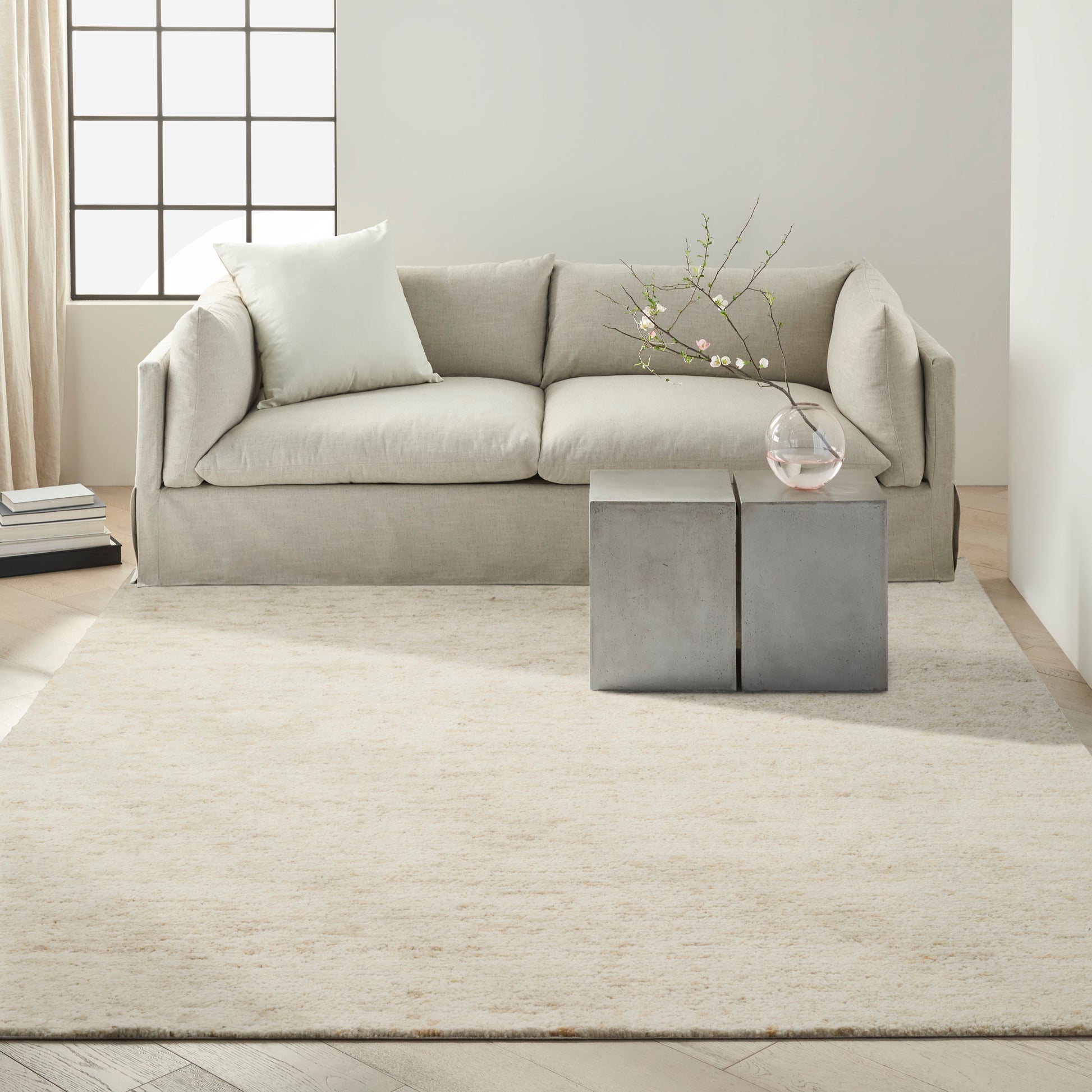 Light gray modern rug, 10' x 14', with a subtle textured pattern.