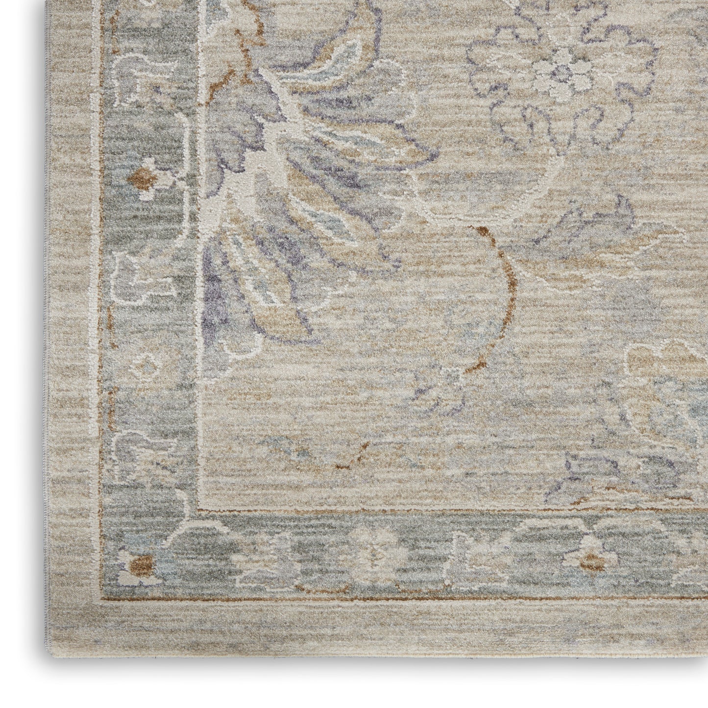 Beige rug with muted blue-gray floral pattern and light border; vintage-inspired, soft woven texture.