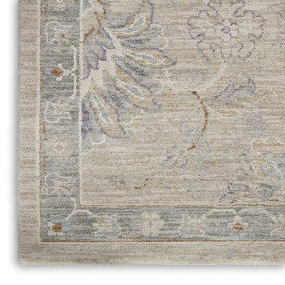 Beige rug with muted blue-gray floral pattern and light border; vintage-inspired, soft woven texture.
