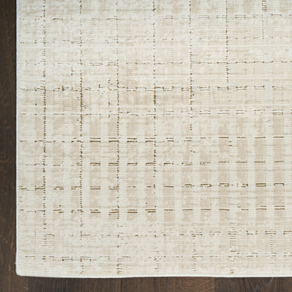 Beige flat-weave rug with subtle grid pattern on dark wooden floor.