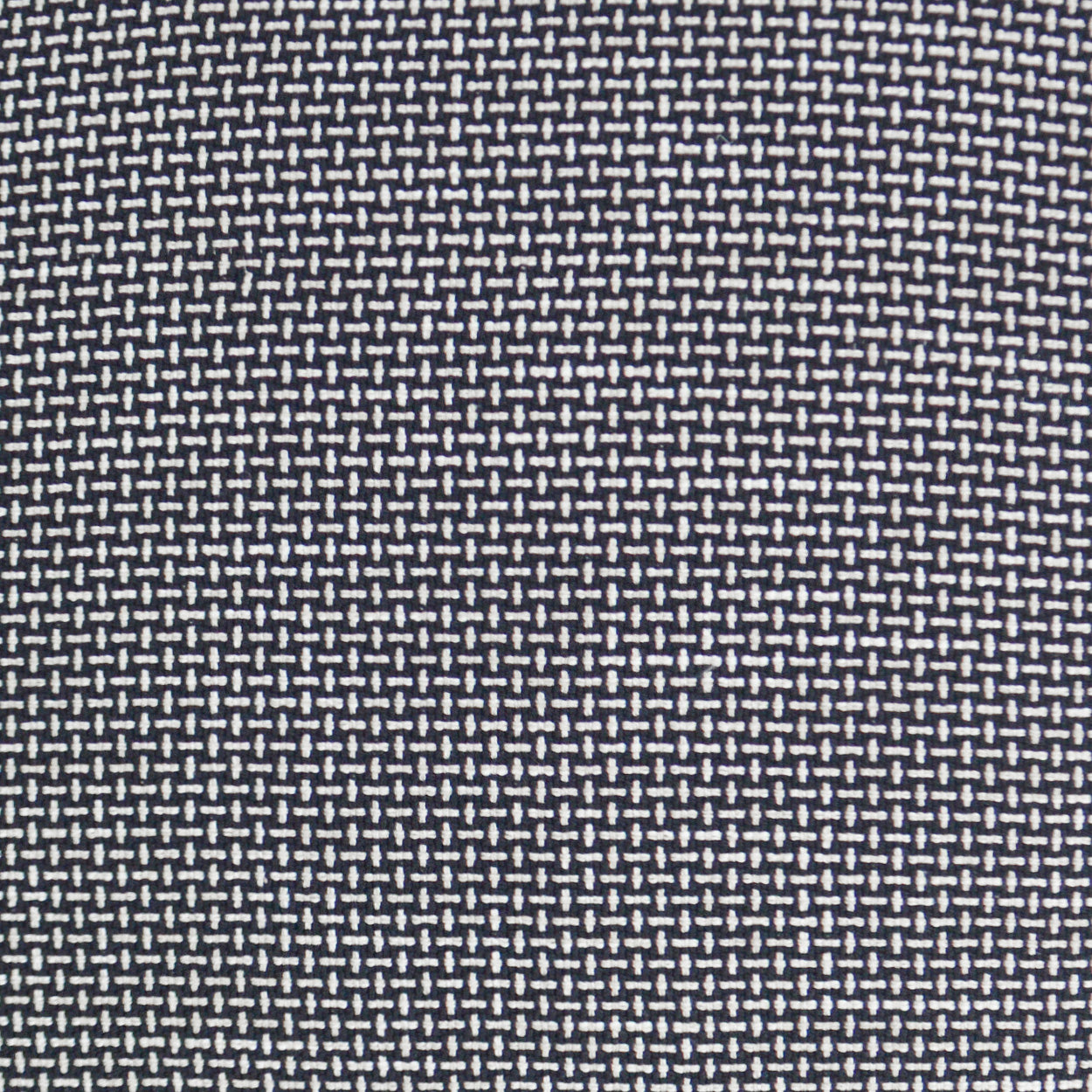 Navy blue woven fabric with tiny white dash pattern, fine texture for upholstery or garments.