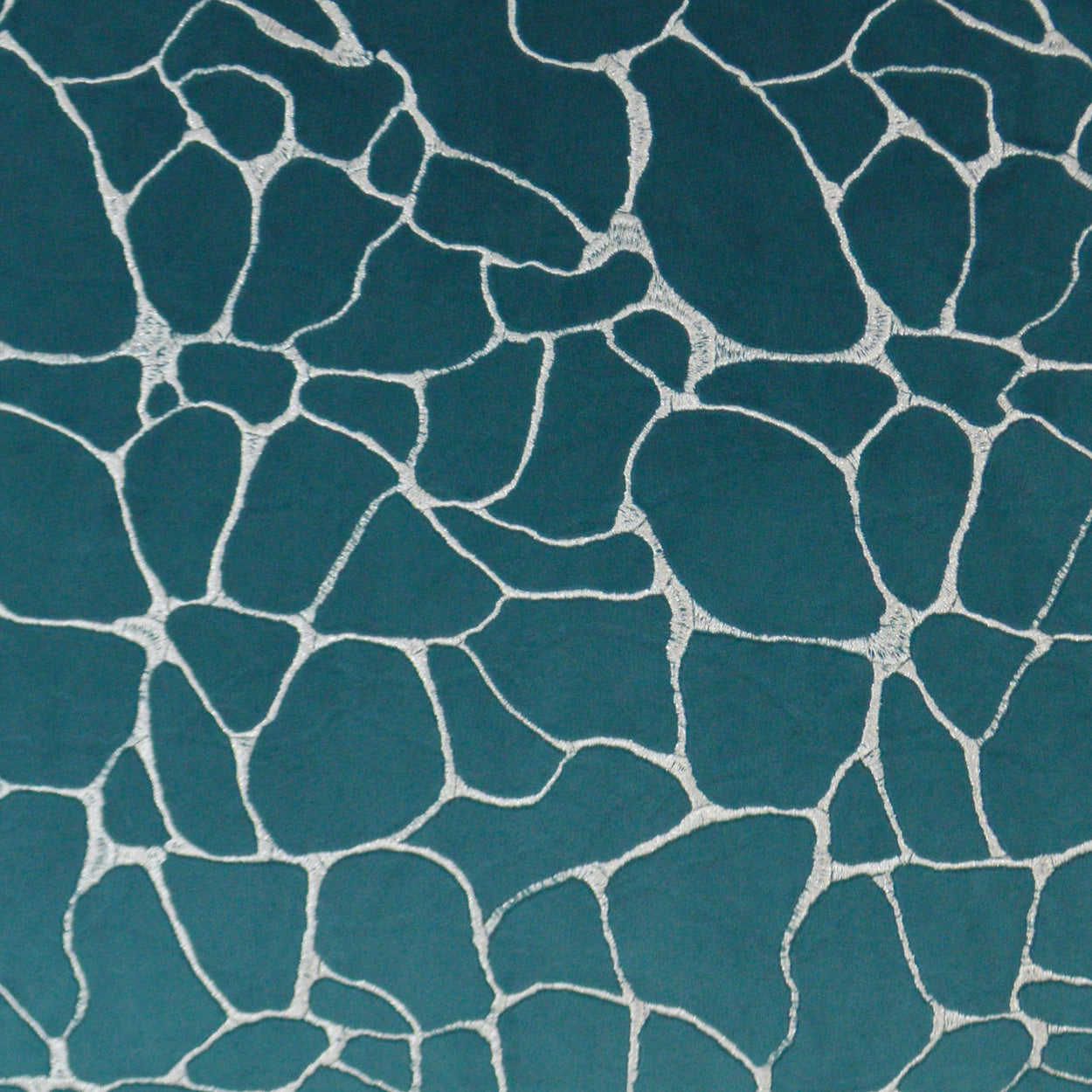 Teal fabric with irregular white mosaic/crack pattern.