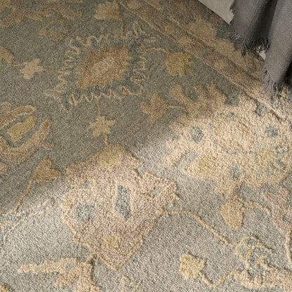 Gray traditional rug with beige, cream and pale yellow floral medallion pattern; soft textured pile, fringe at edge.