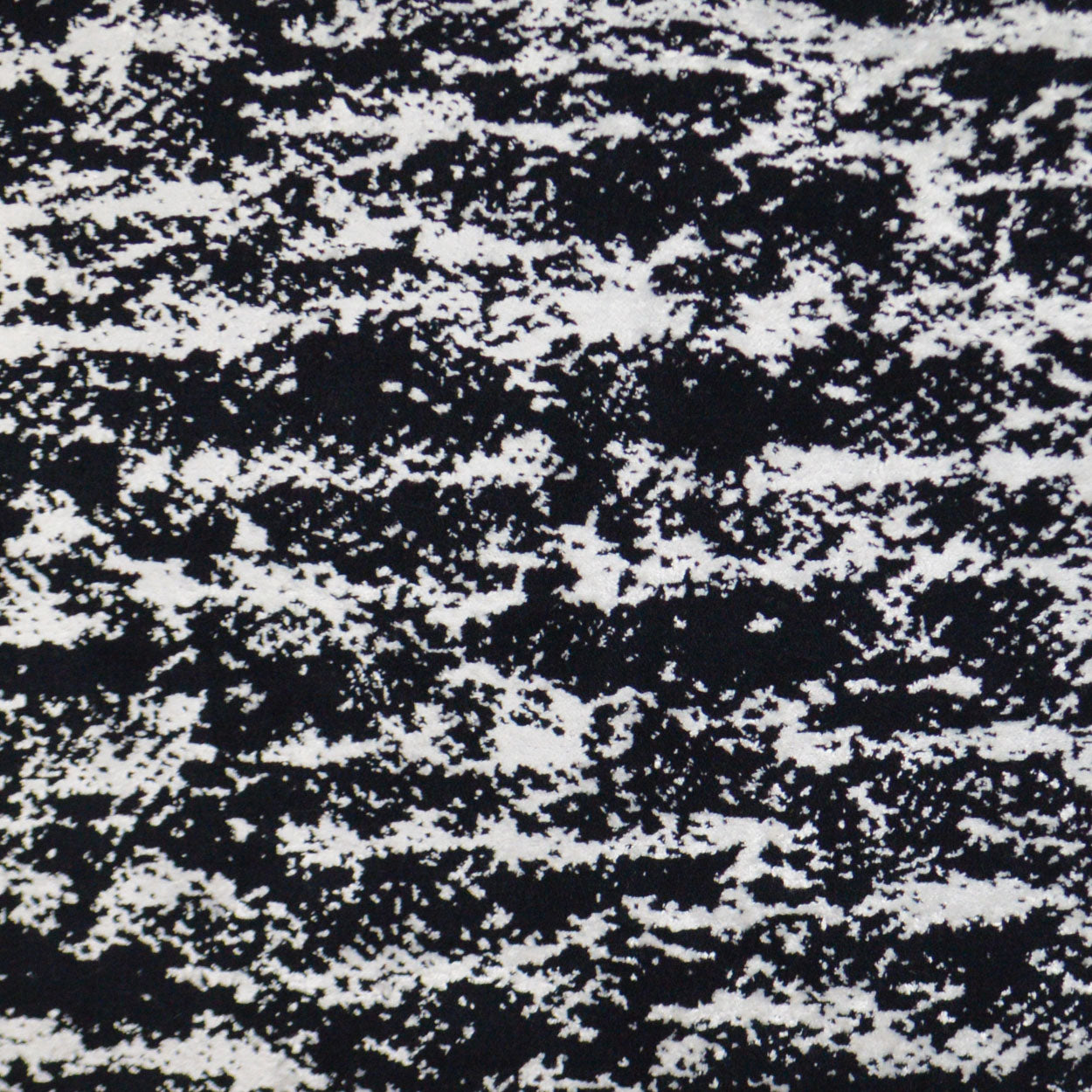 Black and white speckled fabric texture with a marled tweed-like pattern, ideal for upholstery or apparel.