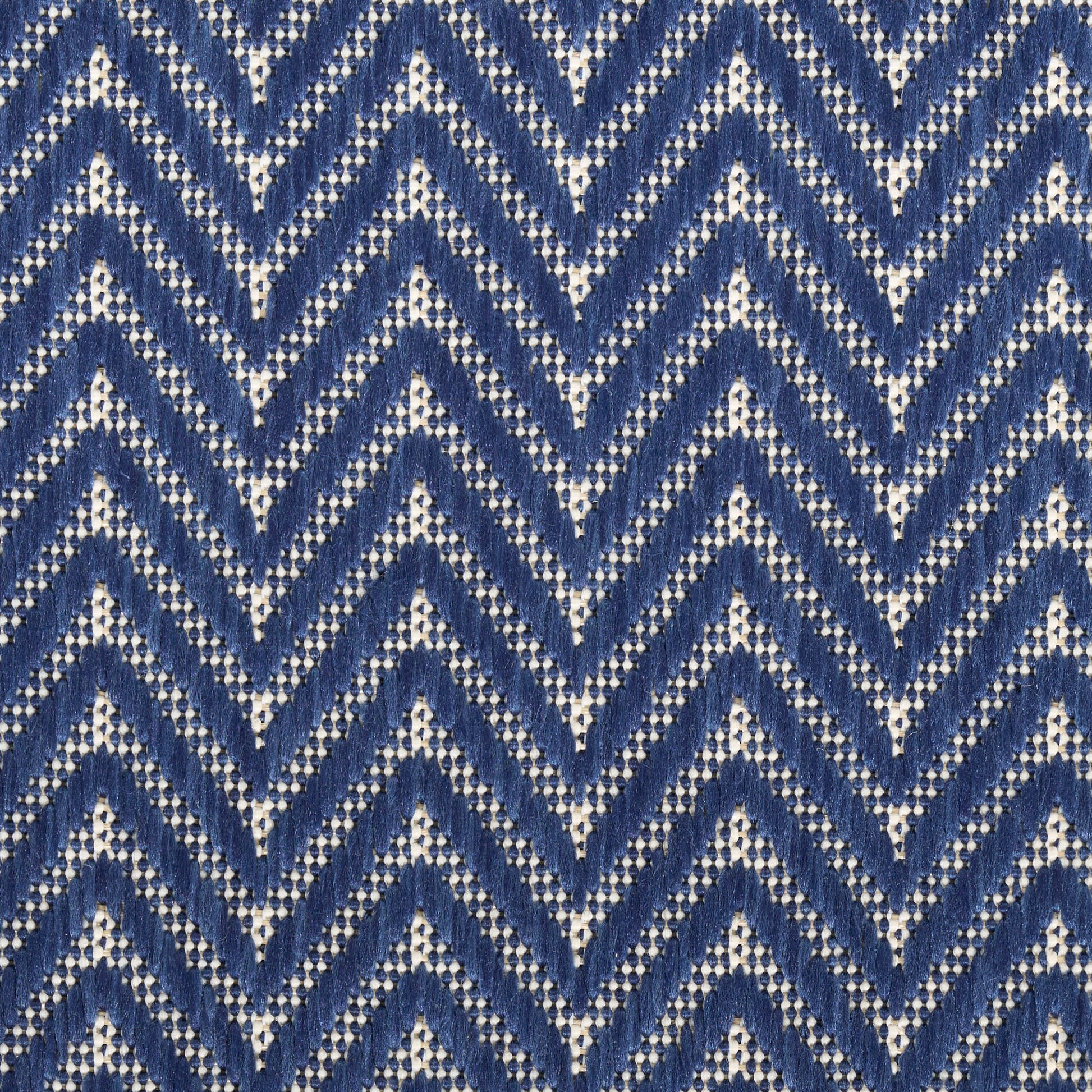 Navy blue chevron rug with white zigzag pattern.