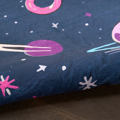 Navy blue rug with space print featuring pink and purple planets, rings, and white stars; soft cotton-like textile.