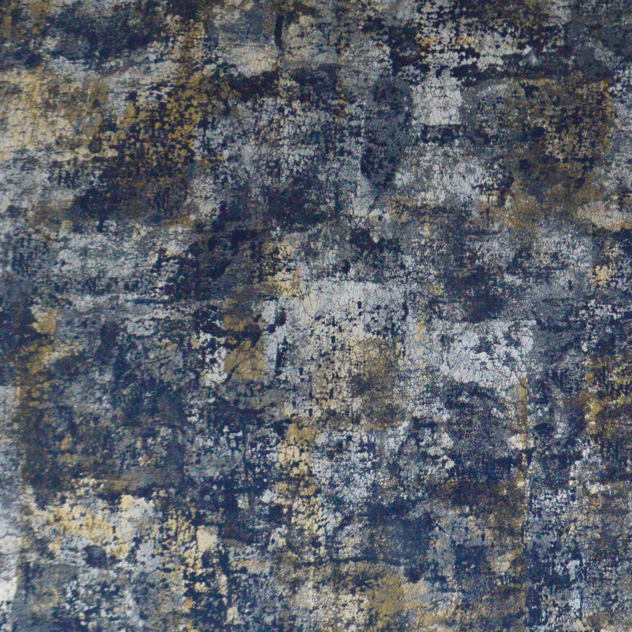 Abstract distressed blue-gray fabric texture with ivory and gold specks, rug-like pattern.
