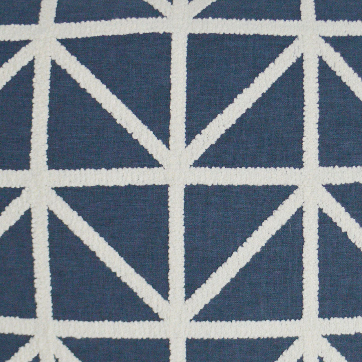 Navy blue fabric with bold white geometric lattice of intersecting lines forming triangles.