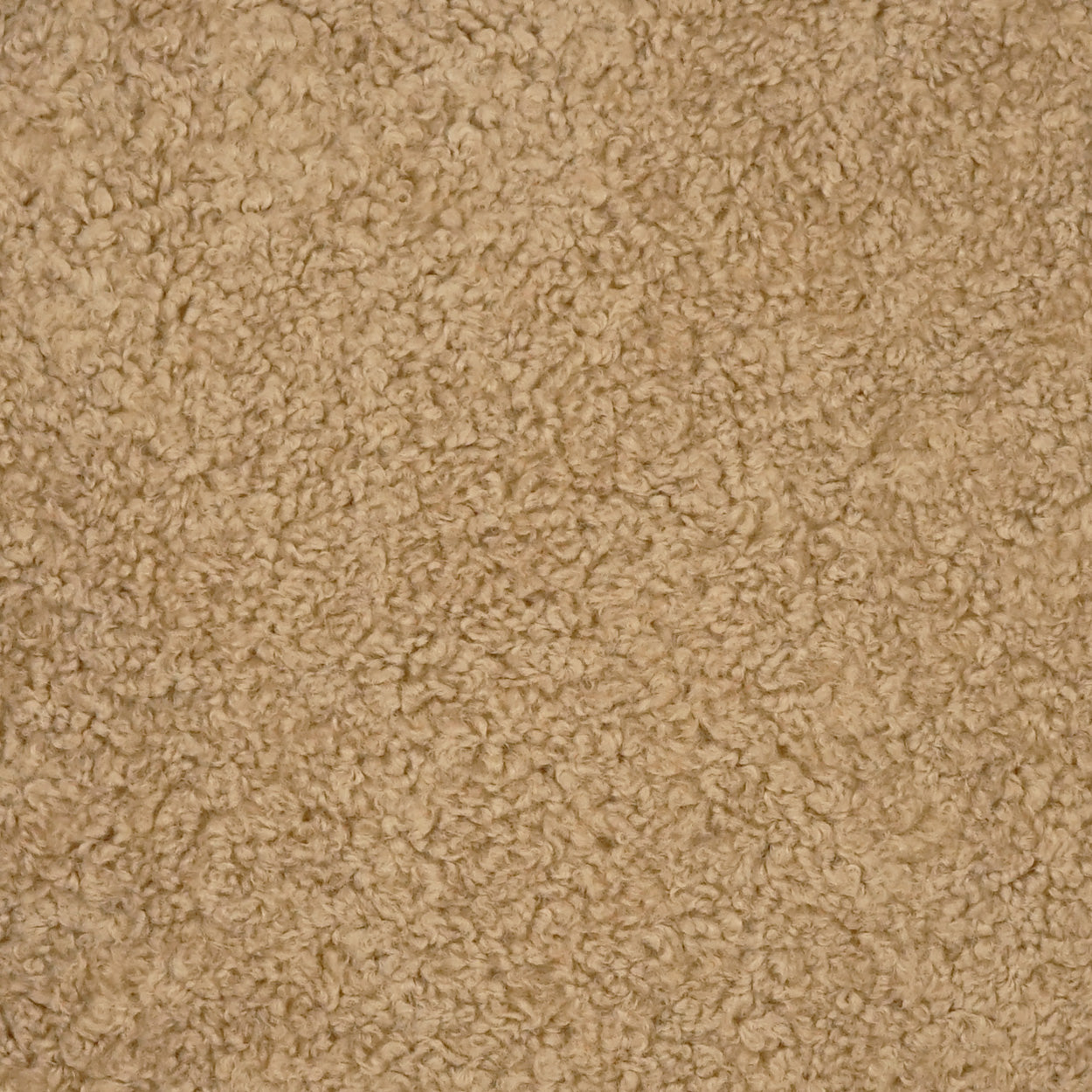 Tan boucle fabric close-up; soft, looped upholstery texture for sofa or rug.