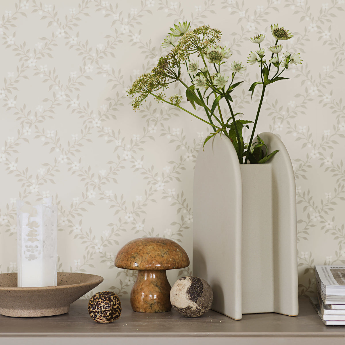 Cream and light gray wallpaper with a soft curved-panel motif; decorative grayscale wallcovering.