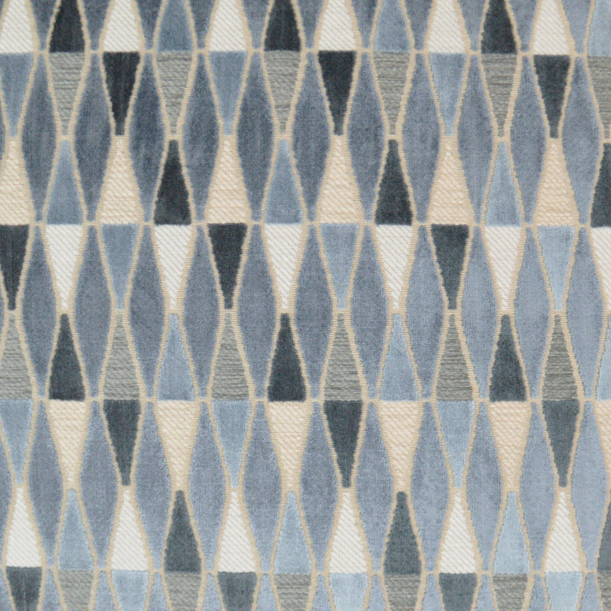 Blue-gray diamond-patterned woven fabric with cream triangles; geometric retro textile.