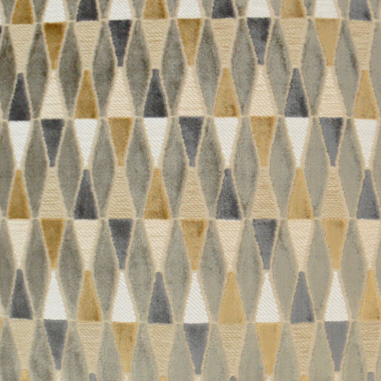 Geometric fabric with repeating beige, gray and mustard triangles forming a diamond pattern; soft woven texture.