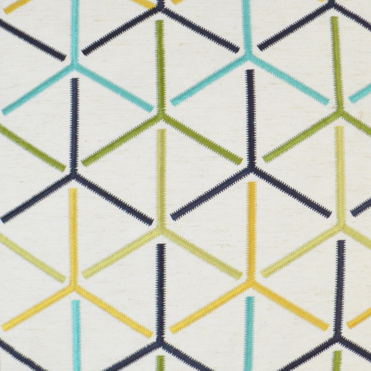 Cream fabric with multicolor geometric stitched pattern in navy, teal, olive green and mustard yellow.