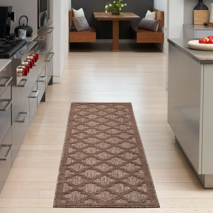 Brown woven runner rug with geometric diamond pattern along a light hardwood kitchen hallway; modern and cozy.
