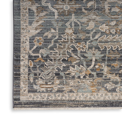 Close-up of a blue-gray oriental rug with ivory beige floral motifs and a decorative border.