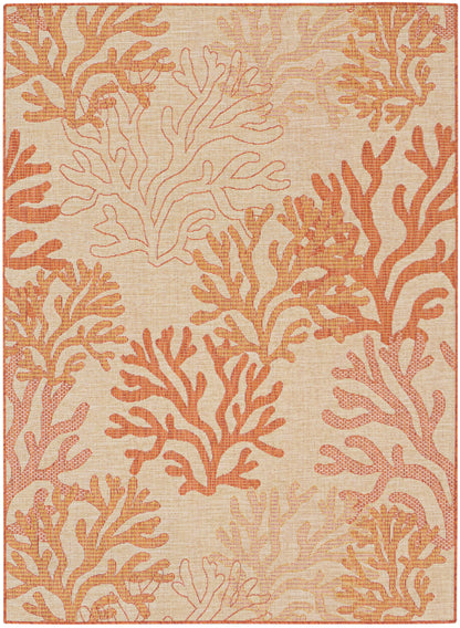 Beige woven rug with coral-inspired orange and peach branches; coastal, decorative pattern.
