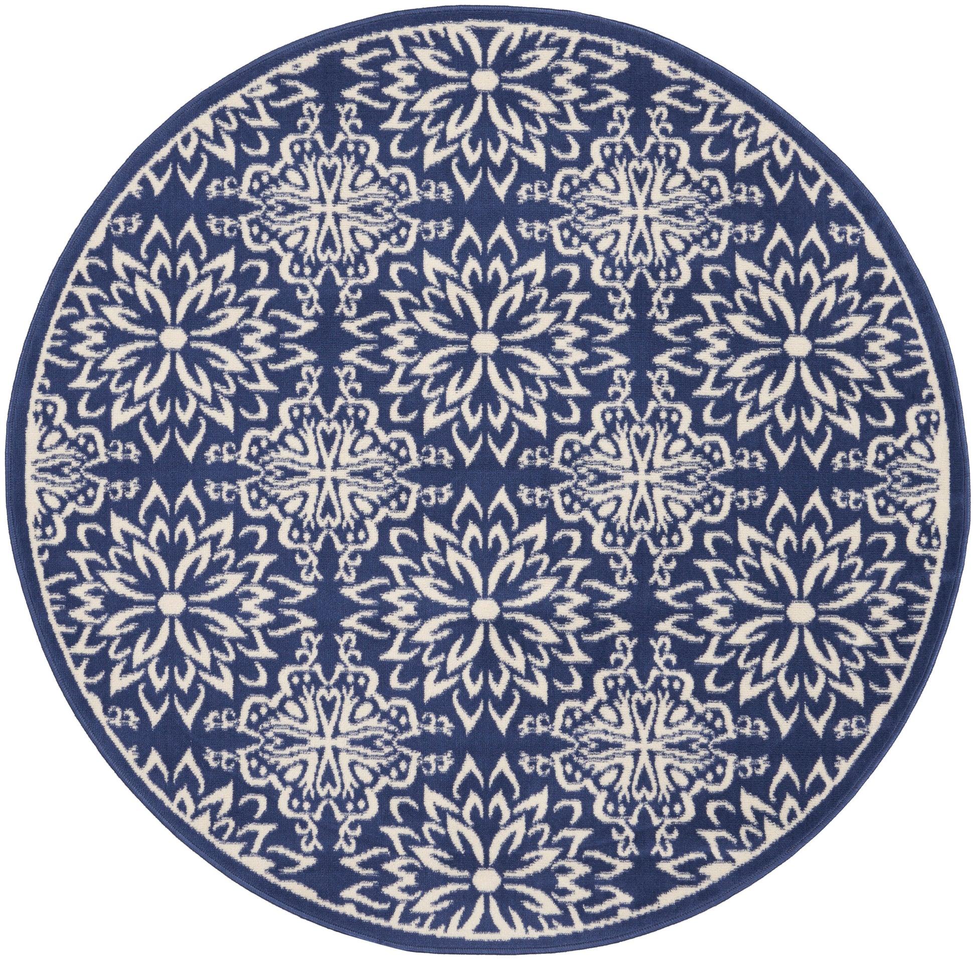 Round navy rug featuring white mandala-style floral motifs in a repeating pattern with a solid border.