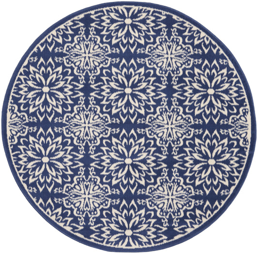 Round navy rug featuring white mandala-style floral motifs in a repeating pattern with a solid border.