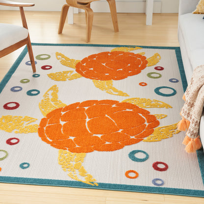 Bright decorative rug with two orange sea turtles, teal border, and colorful ring accents; woven rectangular living room rug
