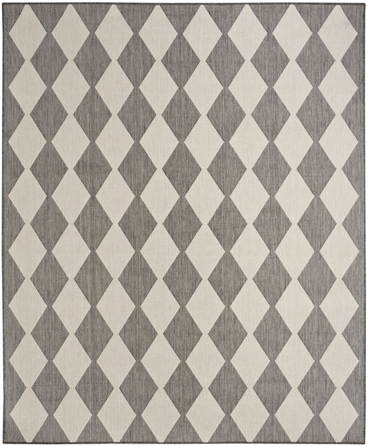 Rectangular rug featuring cream and charcoal-gray diamonds in a repeating geometric harlequin pattern; woven texture.