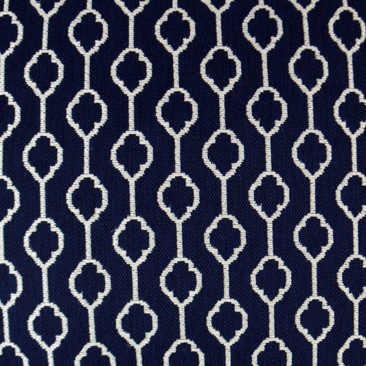 Navy fabric with white repeating geometric lattice and clover-like motifs.