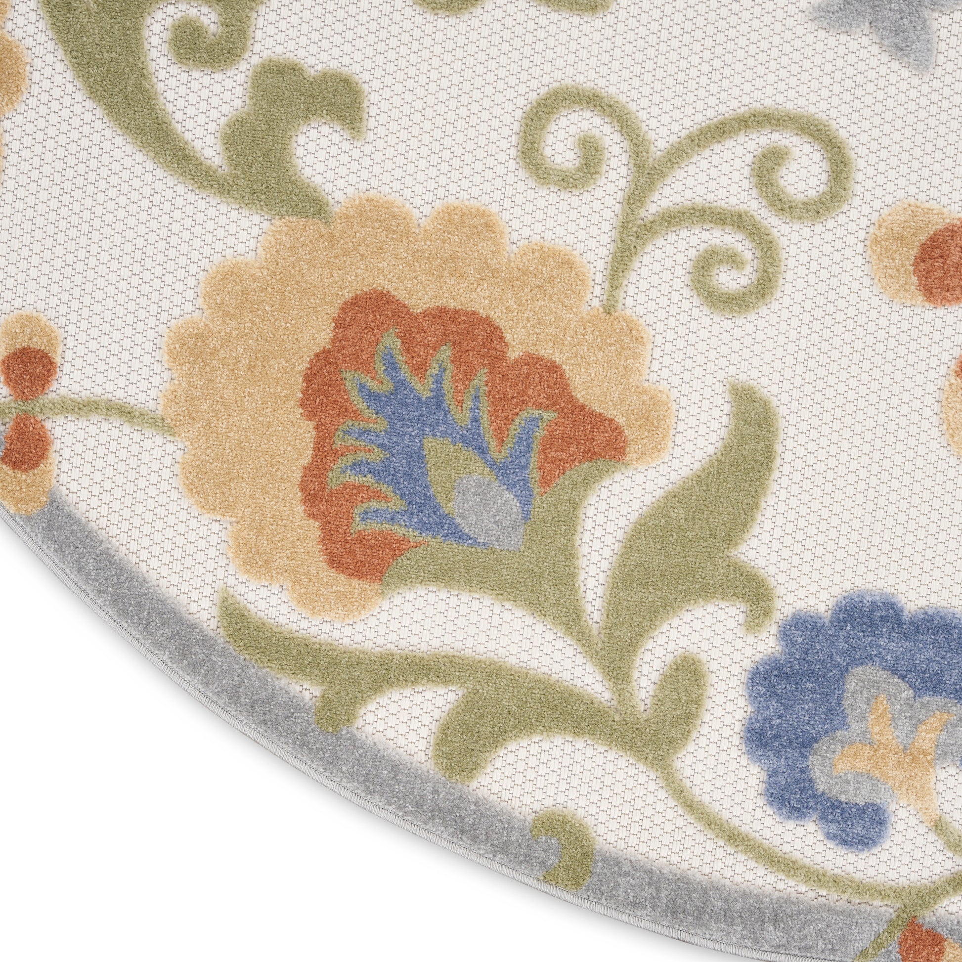 Round outdoor floral rug with cream background, peach scalloped flower, blue and yellow center, green vines, gray border.