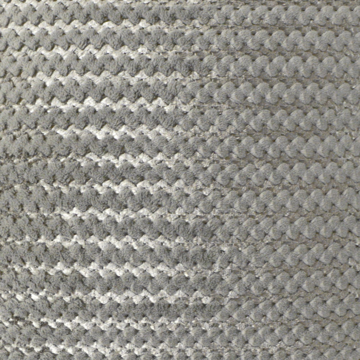 Grey boucle fabric close-up with raised loop texture, upholstery-style textile.