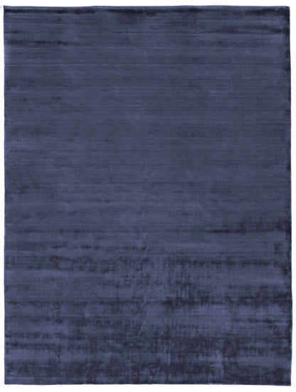 Navy blue rectangular rug with plush velvet-like pile and subtle tonal variation.