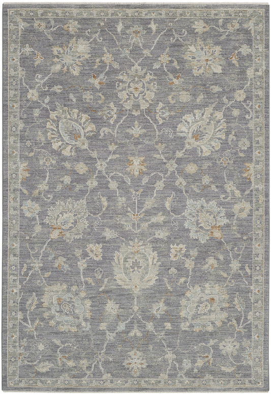 Muted gray-blue traditional floral area rug with ivory/cream & light gold accents, ornate border, woven texture.