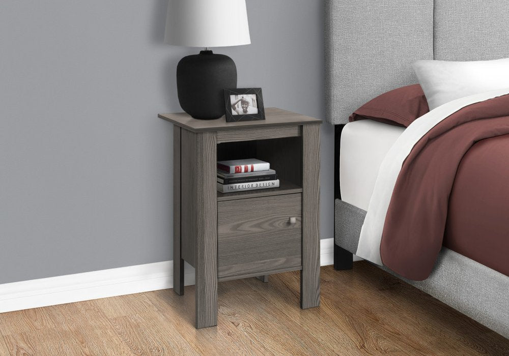 Gray wood end table with shelf; lamp, framed photo & books on the shelf.