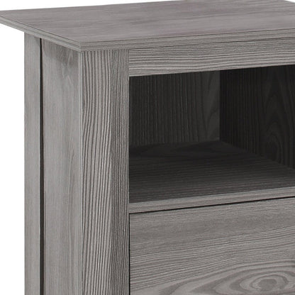 Gray-washed wood end table with top, open middle shelf and bottom drawer.