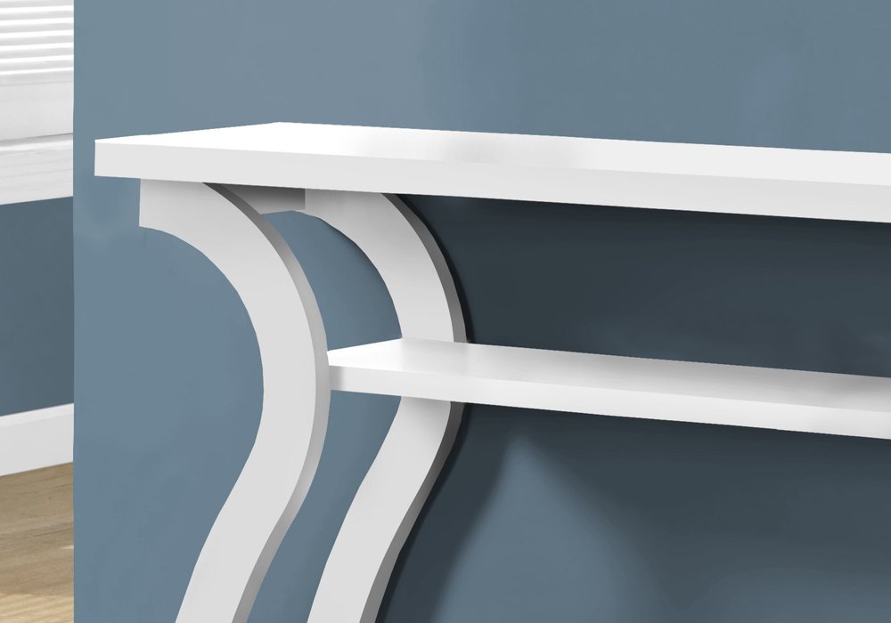 White console with curved double-leg supports and two shelves against a blue-gray wall.