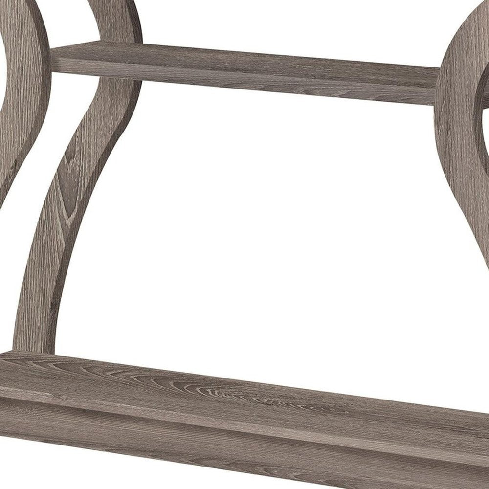 Gray-washed wood furniture frame with curved legs and a crossbar, rustic modern style.