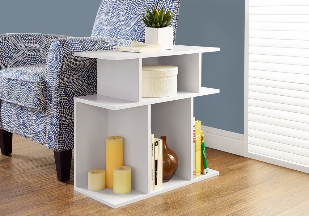 White wooden cube-end table with open cubbies; modern storage for plant, candles and books in a living room.