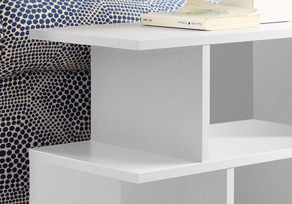 White painted wooden end table with six open shelves; modern minimalist design, books on top.