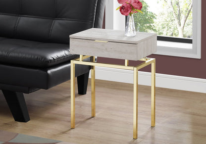 Rectangular beige wood end table with a single drawer on gold metal legs, modern living-room accent.