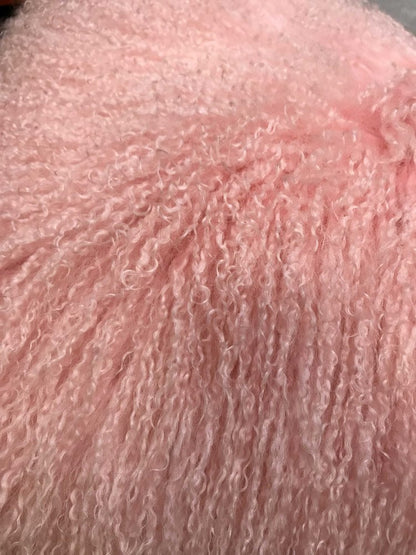 Soft pink plush terry fabric with curly loops; cozy towel or robe texture.