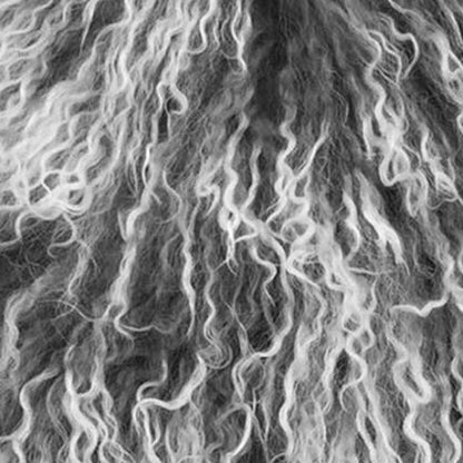 Close-up of 24" grey Tibetan lamb fur pillow surface with microsuede backing; dense, curly fur texture.