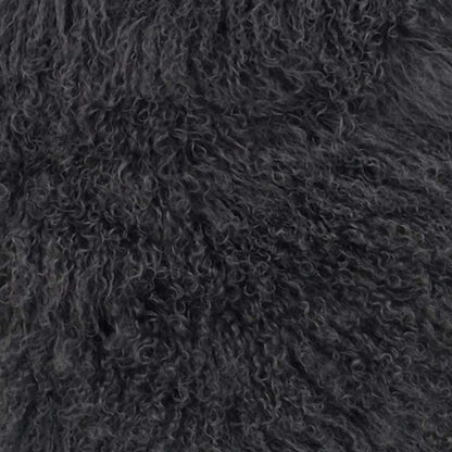 Close-up of dense charcoal genuine Tibetan lamb fur, plush and curly.