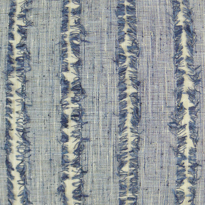 Blue striped woven fringe pillow on a cream background.