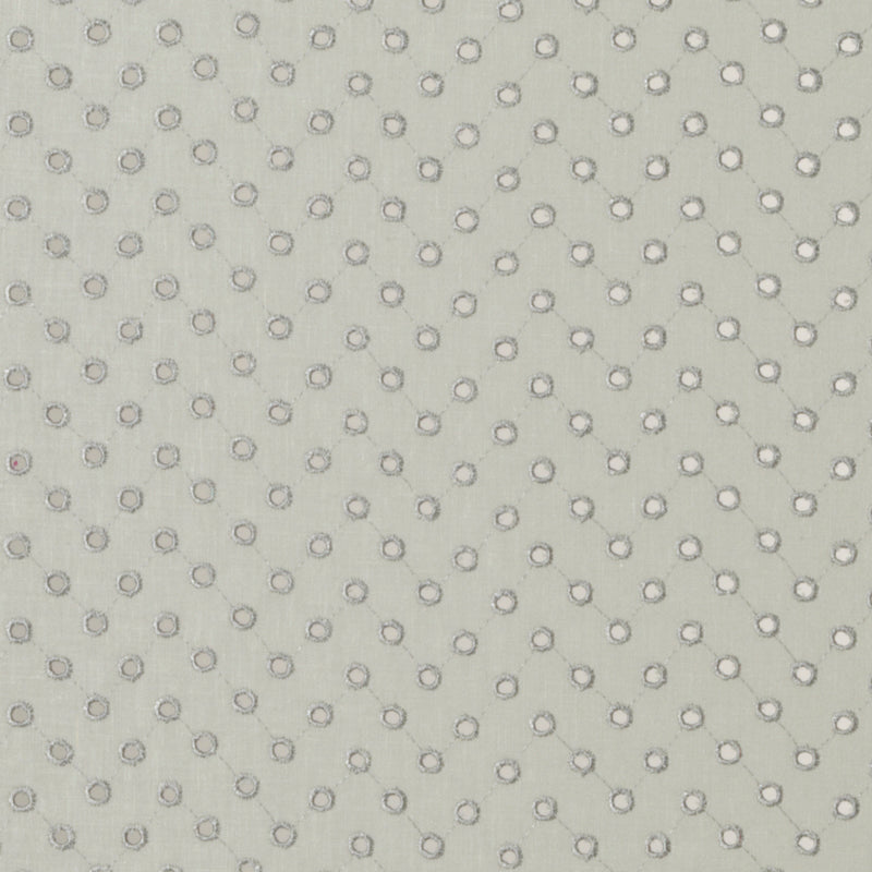 Cream perforated upholstery fabric with tiny circular holes in a diagonal grid.