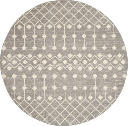 Round taupe rug with cream lattice diamond pattern and striped bands for a modern geometric look.