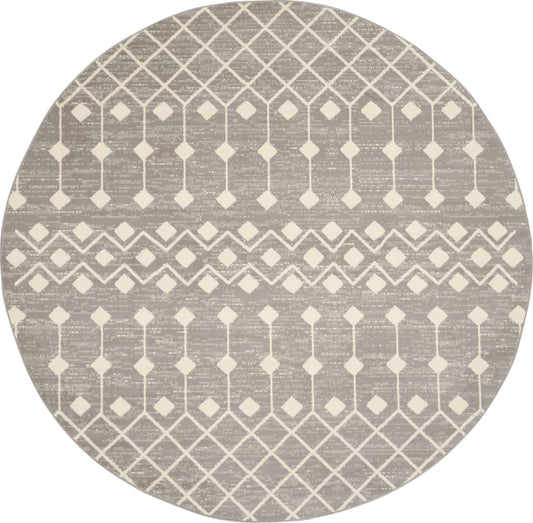 Round taupe rug with cream lattice diamond pattern and striped bands for a modern geometric look.