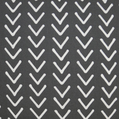 Dark gray fabric with repeating white chevron (V) motifs on a 24" x 24" pillow; modern geometric pattern.